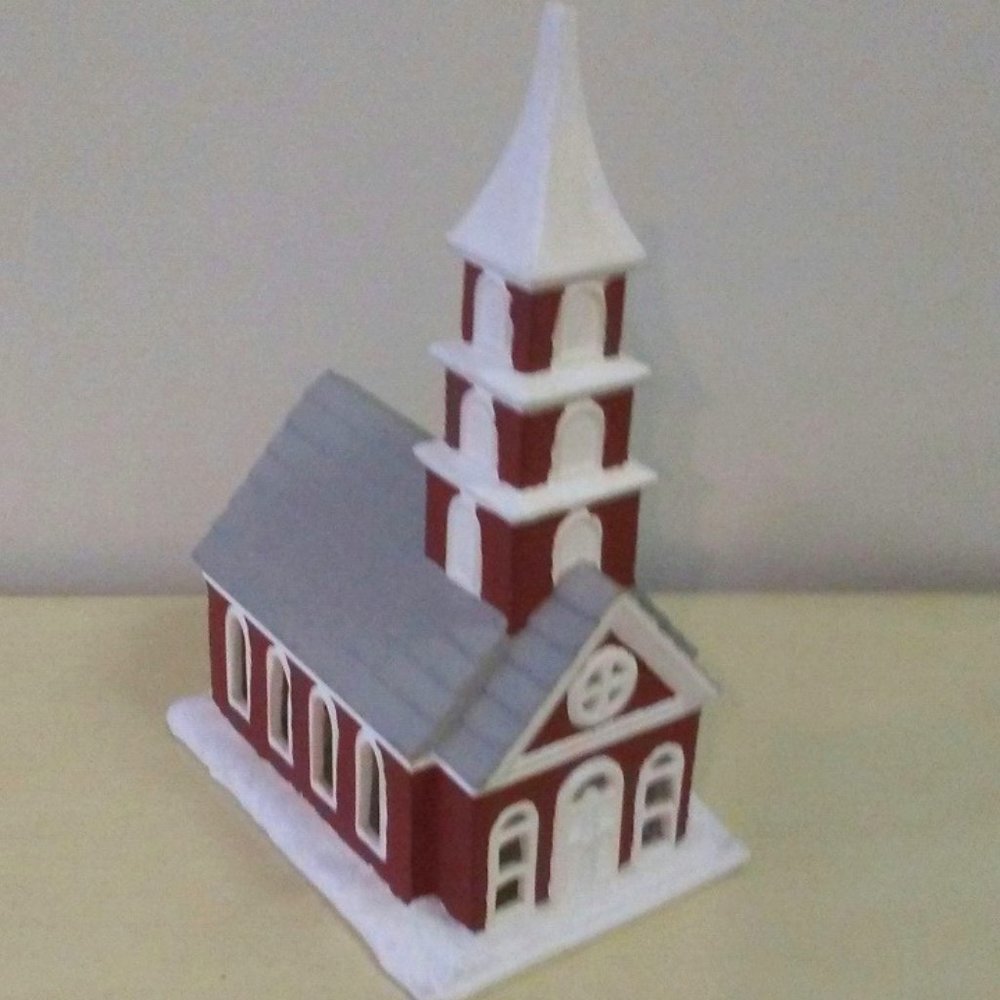 Ceramic church with cut-out windows on front, back and sides.